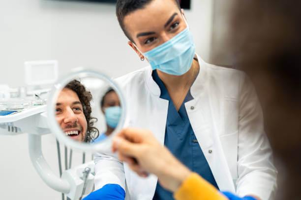 a person smiling confidently with a set of newly applied veneers