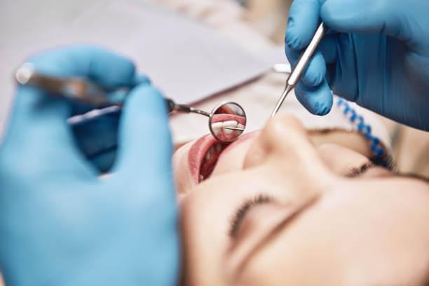 dentist examining a patient during a routine dental visit