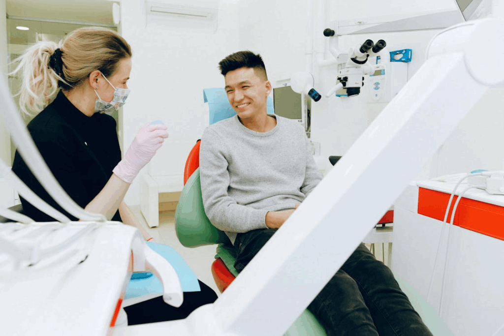 a man smiling at the dentist during a consultation