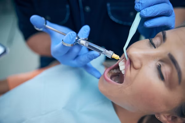 image showing a person with mouth wide open during a dental procedure