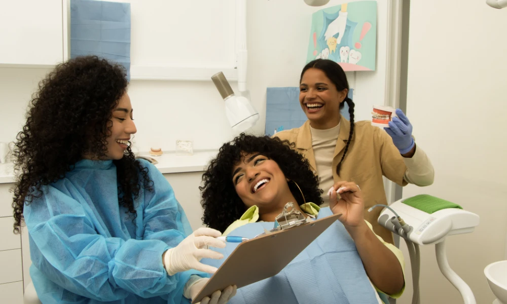 friendly dental team assisting a smiling patient during a saturday dental visit