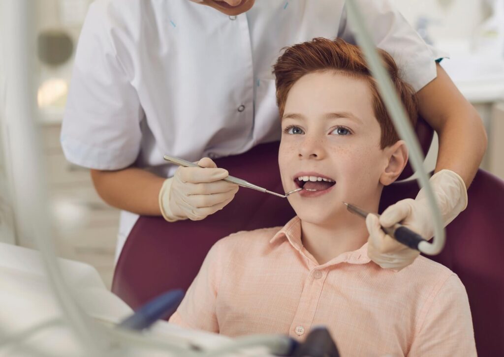 Child receiving a dental examination before placement of kids dental spacers to help maintain proper spacing for permanent teeth.