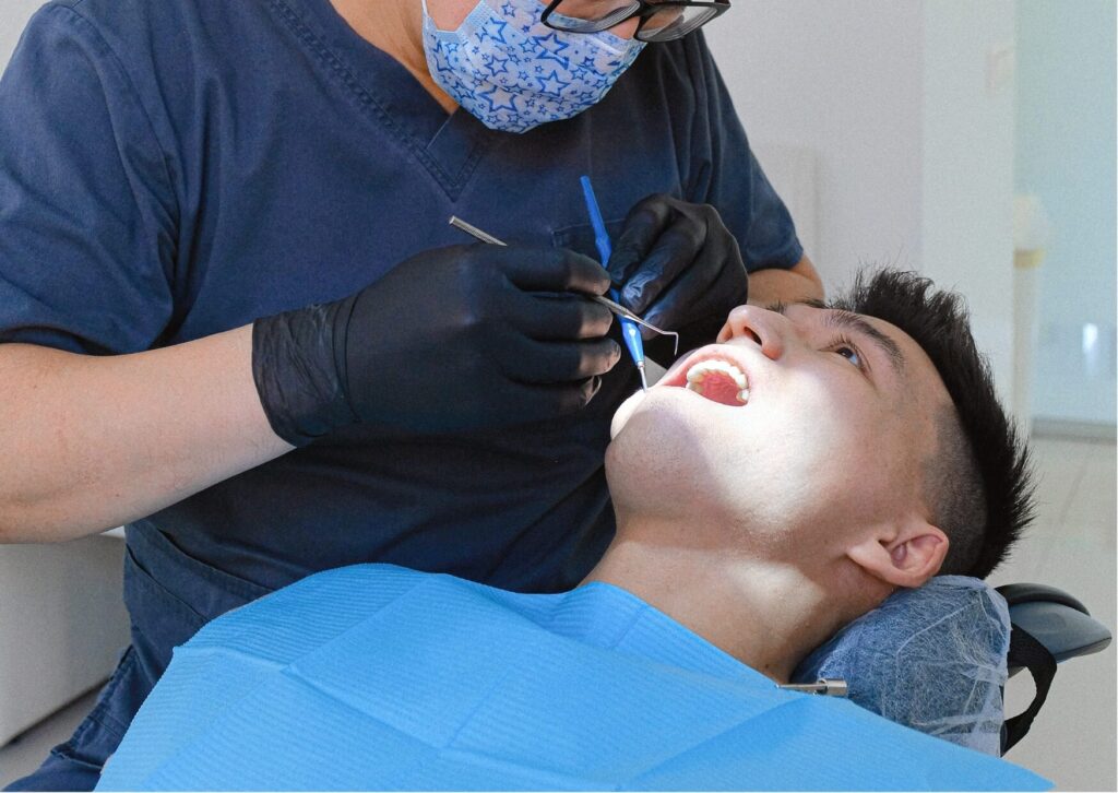 Dentist examining a patient with tooth pain during an appointment to diagnose the cause and provide toothache relief.