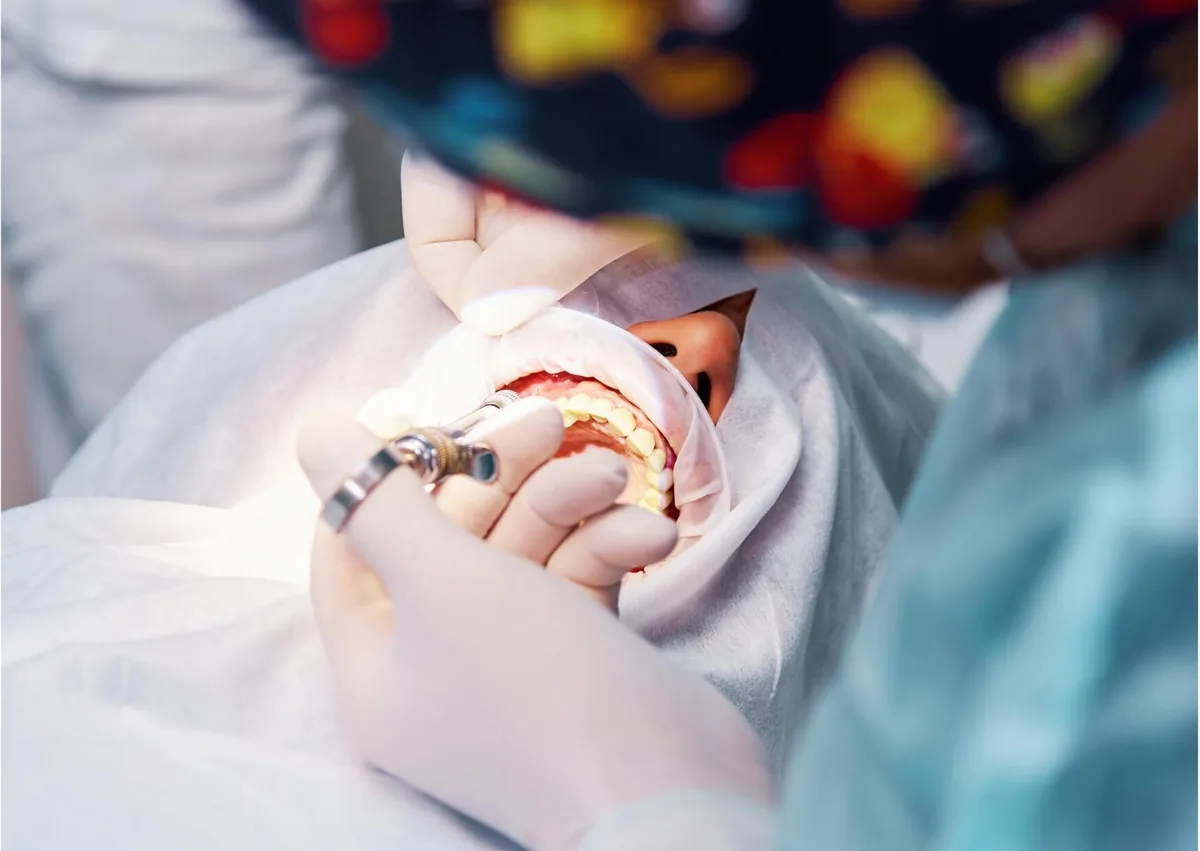 Dentist performing a dental procedure that may be used as part of gummy smile treatment.