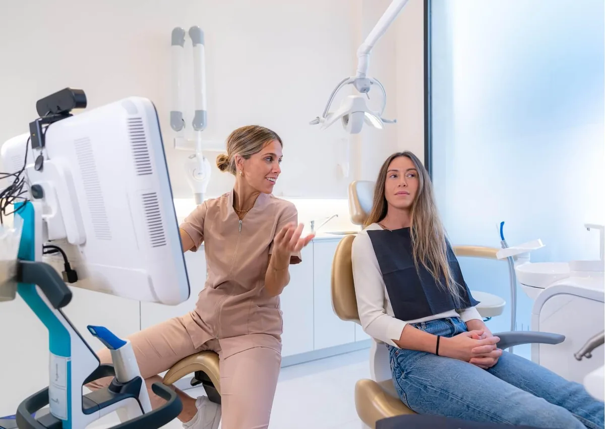 Dentist discussing post-operative instructions with a patient about avoiding dairy after dental implant surgery.