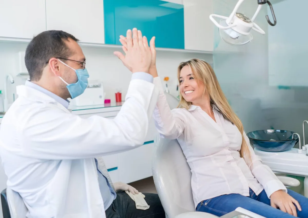 Dentist and patient discussing oral health and the number of teeth in the human mouth.